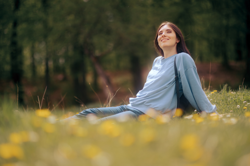 young woman sitting in grass